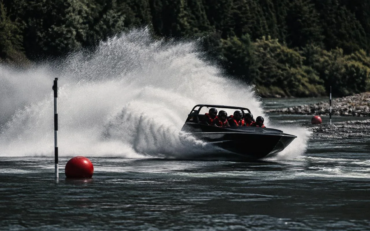 Jetboat carving a turn with spray rising across the river